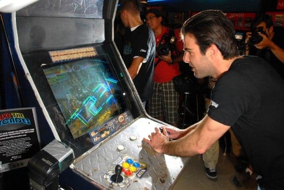 zachary quinto playing an arcade game
